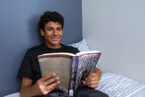 Teen reading in bed