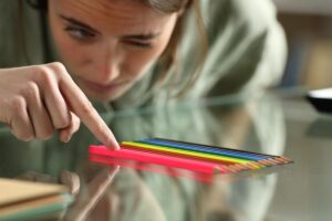 Teen girl looks at her colored pencil collection while pondering the different types of OCD