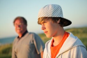 Father and son stand outside and have heated discussion about toxic behavior and unhealthy relationships within the family