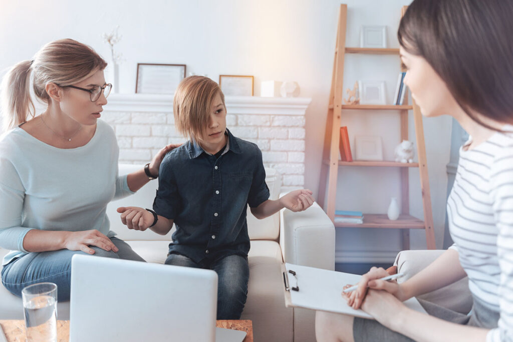 Adults talk to child and wonder after noticing signs of bipolar disorder