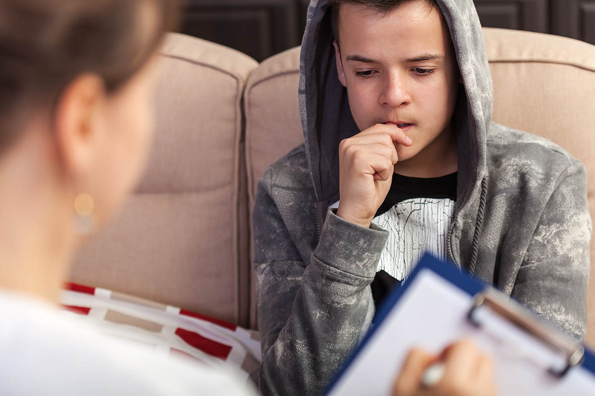 Teen boy hearing about depression in teen boys