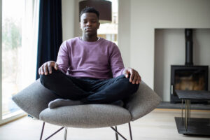 A man experiencing the benefits of meditation therapy