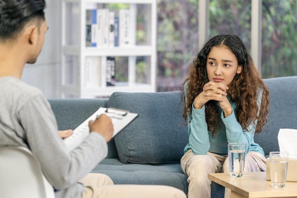 behavioral health therapist talking to teenage girl about managing anxiety in kids and teens