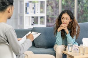 behavioral health therapist talking to teenage girl about managing anxiety in kids and teens